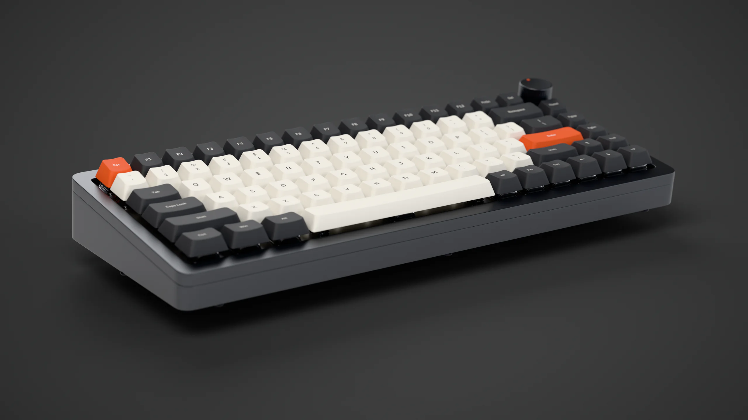 The AGENT75 mechanical keyboard, cream and grey keycaps with orange Esc and Enter keys, on a dark studio floor.